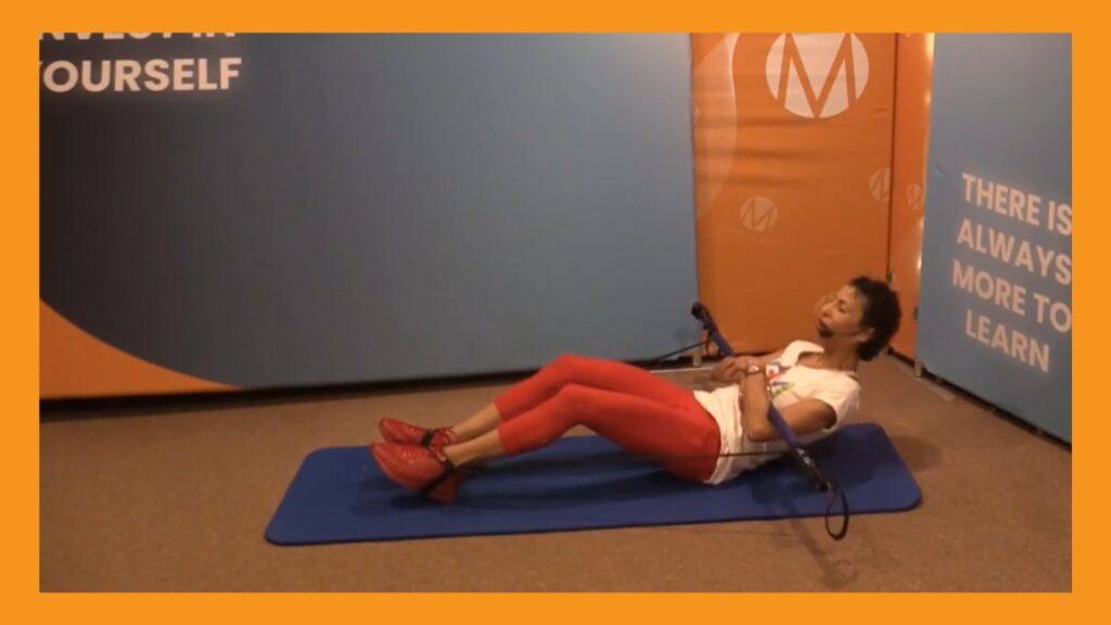 Marietta Mehanni performing a Seated abdominal recline using a Gymstick. Blog titled Gymstick Guide to Abdominal Strength by Marietta Mehanni
