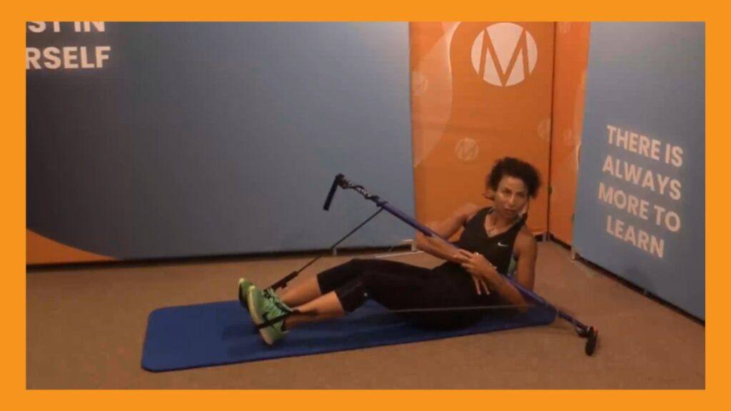 Marietta Mehanni performing a seated recline with rotation using the Gymstick resistance tool. Blog by Marietta for a Gymstick Guide to Abdominal Strength